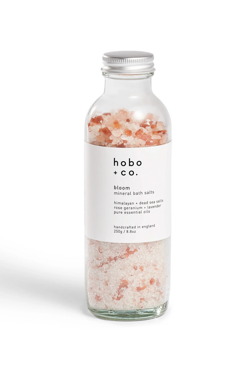 Glass bottle of pink and white Himalayan bath salts from British indie Hobo + Co