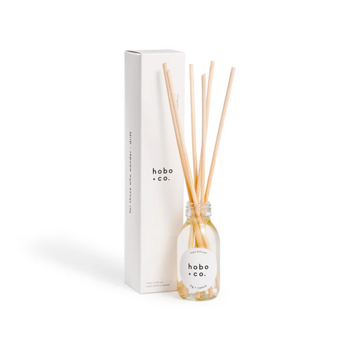 reed diffuser set with clear glass bottle and six reeds, shown with white card Hobo + Co. branded box
