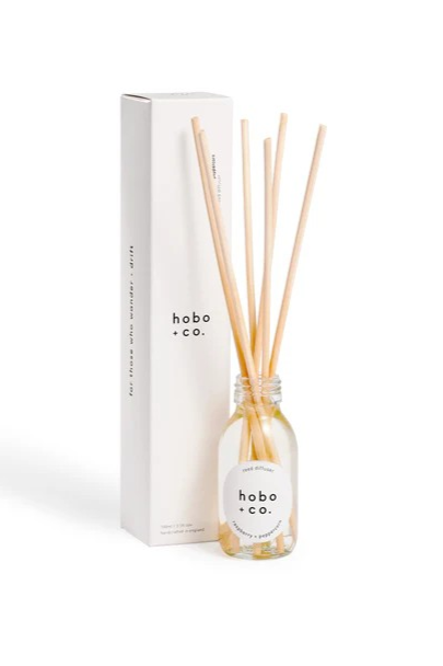 Hobo + Co. branded Reed Diffuser in Clear Glass bottle with six light beige reeds