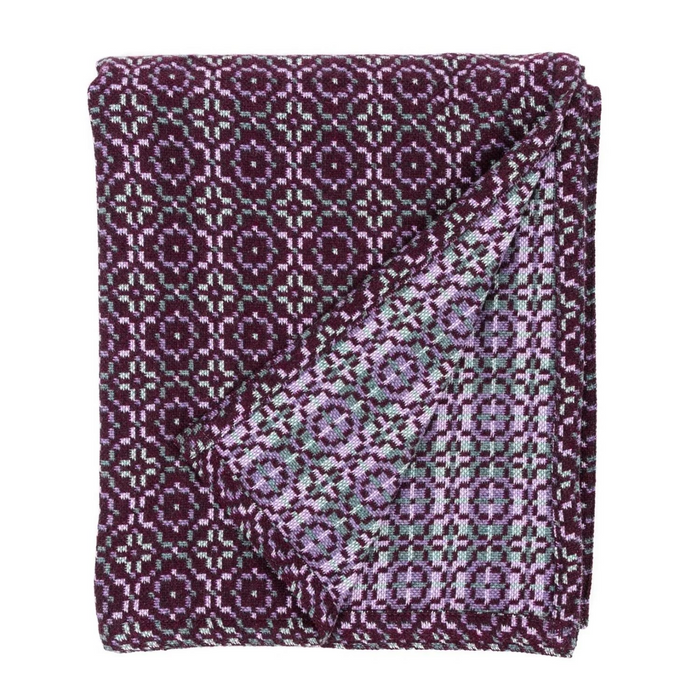 woven wool throw or blanket in dark purple with lilac and grey pattern details