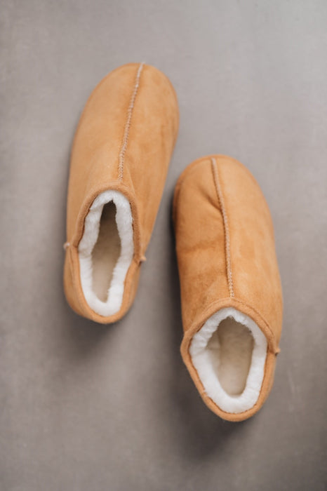 Traditional women’s sheepskin slippers with hand-stitched detailing and wool lining.